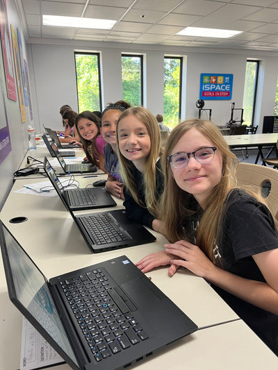 Girls with computers.jpeg__PID:09854ab3-05f6-4a53-a737-2515a5a519bb